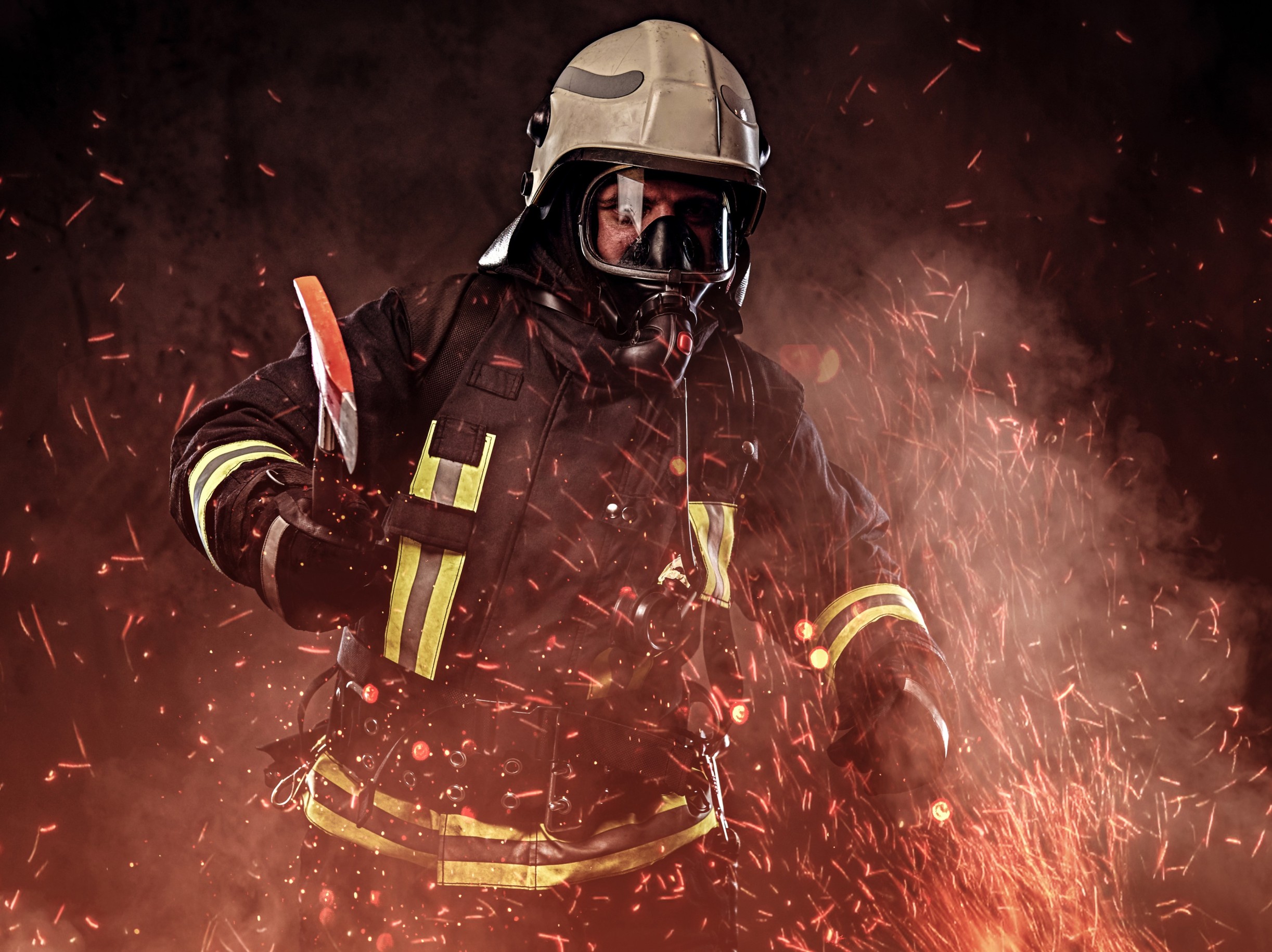firefighter dressed uniform oxygen mask holds red axe standing fire sparks smoke dark background (1) (1)